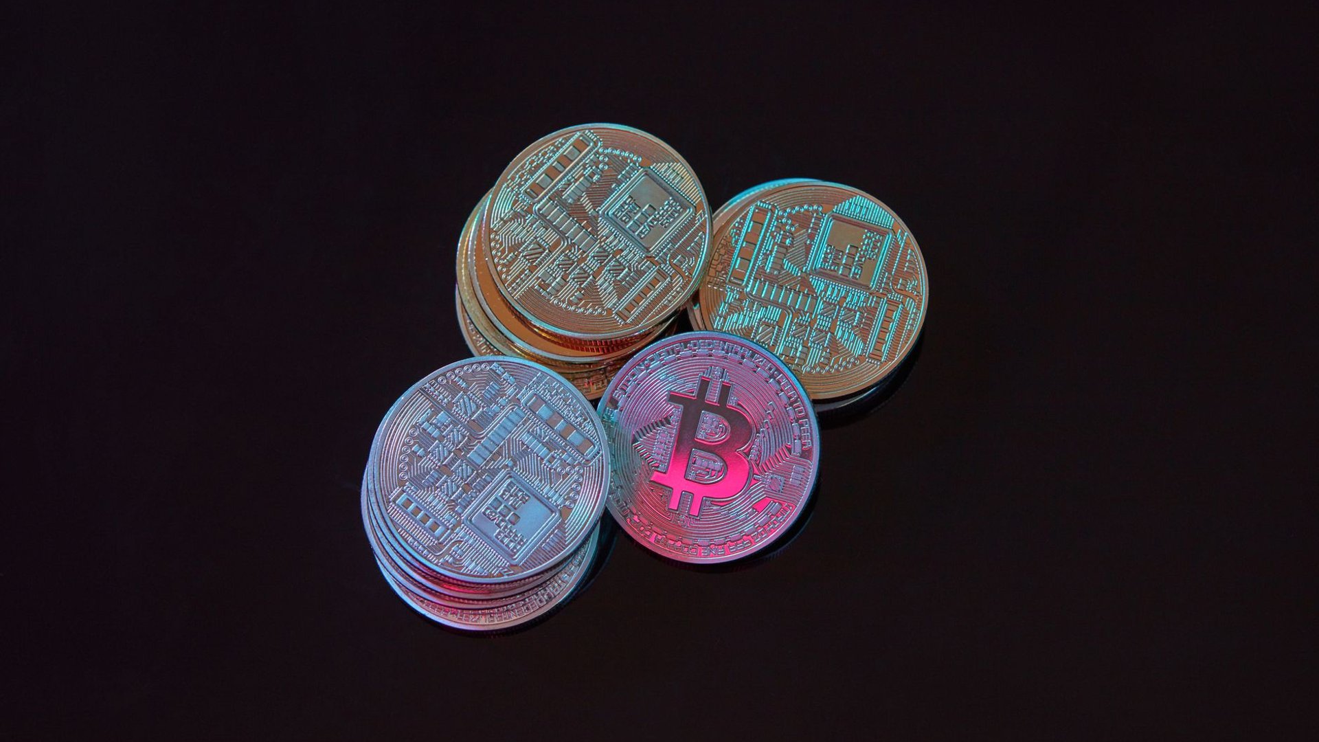 Bitcoin-Münzen im Farblicht, Symbolbild Steuerfreiheit von Glücksspielgewinnen